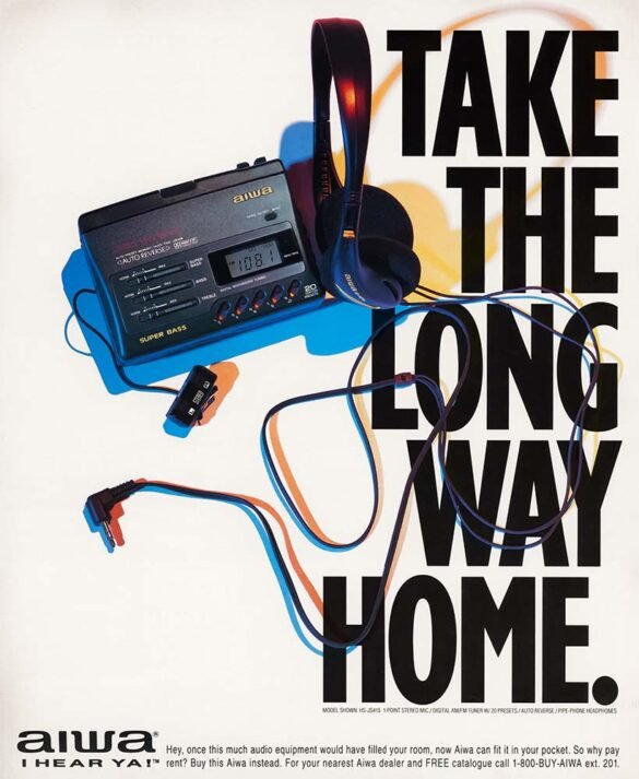 1994 Aiwa advertisement showing a black portable cassette player, headphones and cables beside the large slogan “Take the Long Way Home.”