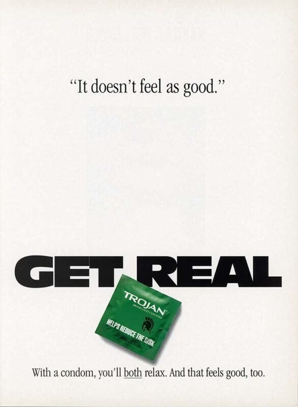 Minimalist Trojan condom advertisement with the phrase “It doesn’t feel as good,” large “GET REAL” lettering, and a green condom package near the bottom.